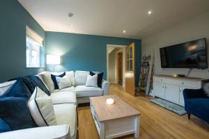 a living room with a couch and a tv at The Briers Country House in Newcastle