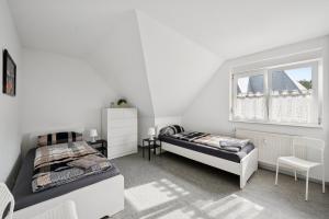 a bedroom with two beds and a window at Worker Place Lennestadt in Lennestadt