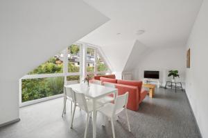 a living room with a red couch and a table at Worker Place Lennestadt in Lennestadt