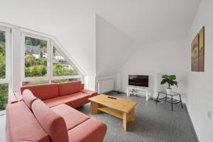 a living room with a couch and a table at Worker Place Lennestadt in Lennestadt