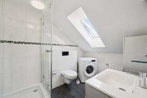 a white bathroom with a toilet and a sink at Cosy Worker Apartment Olpe in Olpe
