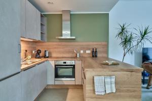 a kitchen with stainless steel appliances and wooden counters at Riverside Holiday in Eupen