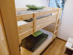 a wooden bunk bed with pillows on top at Riverside Holiday in Eupen