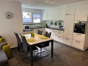 a kitchen with a table and chairs in a room at Papillon in Saas-Grund +31 photos