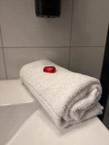 a white towel with a red candle on top of it at Fishermans Villa Ballstad - Lofoten in Ballstad +48 photos
