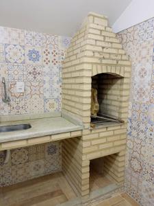 a brick pizza oven in a kitchen with tiles at Deruci Chale in Nova Friburgo +35 photos