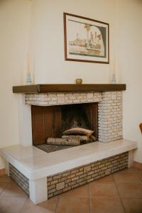 a living room with a brick fireplace at La Casetta - un piccolo angolo di pace in Piccianello +24 photos