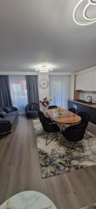 a living room with a table and chairs at LuxAsher in Floreşti