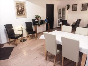 a dining room with a white table and chairs at A-Piramida in Wrocław