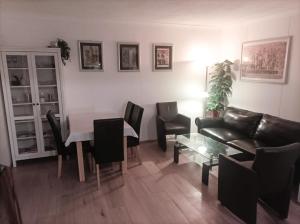 a living room with a couch and a table and chairs at A-Piramida in Wrocław
