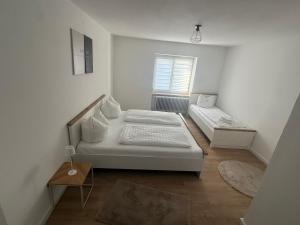 a white room with two beds and a window at Lina Ferienhaus in Longkamp