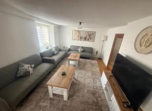 a living room with a couch and a coffee table at Lina Ferienhaus in Longkamp