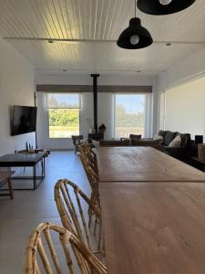 a living room with a large wooden table and chairs at Nuestro Lugar Soñado in Concepción del Uruguay