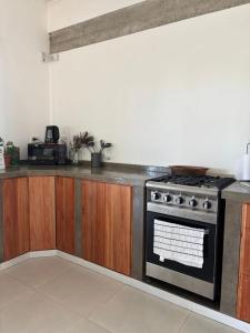 a kitchen with a stove and a counter top at Nuestro Lugar Soñado in Concepción del Uruguay
