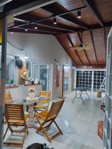 a living room with a ping pong table and chairs at Miranda House in Estancia San Ramon