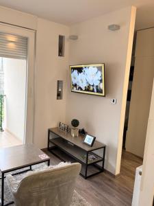a living room with a table and a painting on the wall at Perfect Place 32 in Varaždin