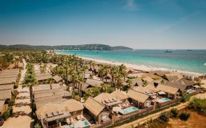 an aerial view of a beach with houses and palm trees at Kon Tiki in Saint-Tropez
