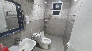 a small bathroom with a toilet and a sink at Suhail Star Guest House in Misfāh +29 photos