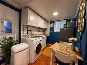 a kitchen with a sink and a washing machine in it at Studio Sto Antonio Alfama in Lisbon