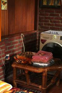 a table with a stack of blankets on top of it at Swindo Homestay 77, Small House in Berastagi