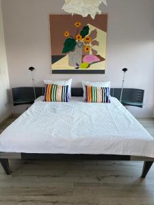 a large bed in a room with two pillows at Lekerweg 32 in Wijdenes
