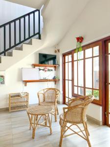 a living room with two chairs and a table at Dew Ceylon Villa Negombo in Negombo