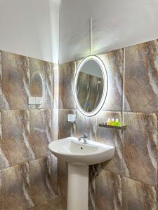 a bathroom with a sink and a mirror at Dew Ceylon Villa Negombo in Negombo +30 photos