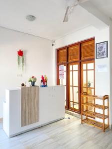 a kitchen with a refrigerator and a wooden ladder at Dew Ceylon Villa Negombo in Negombo