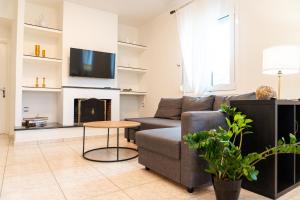a living room with a couch and a fireplace at Dimeli 3 in Litochoro