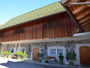 a large stone building with a wooden roof at FEWO Weber in Lukowitz