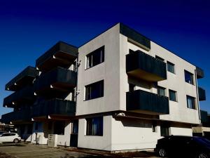 a building with balconies on the side of it at Flat 6 - Luxury Designer Apartment in Odăile