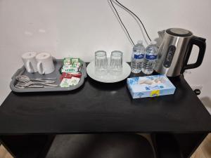 a table with a tray of food and water bottles at Comfort Lodge in Nottingham