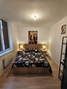 a bedroom with a large bed in a room at L'Artiste in Chauny