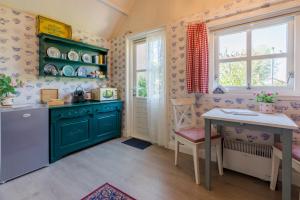 a kitchen with green cabinets and a table at Zalk blijven slapen in Zalk +23 photos