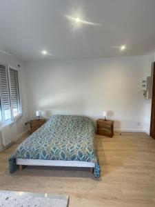a bedroom with a bed and two night stands at - General L - in Obernai