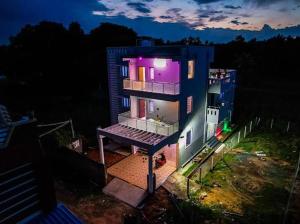 a large house with a purple light on it at night at The Sunshine Villa in Pondicherry