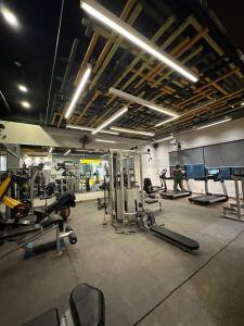 a gym with lots of equipment and people in it at AuraStays in Dargai