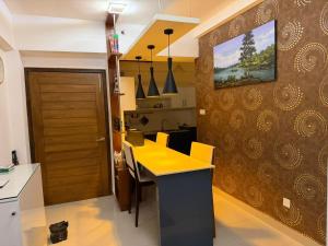 a kitchen with a yellow table and a wall at Oval View Residencies By C in Colombo