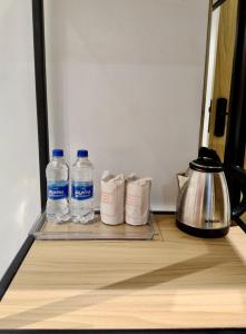 two bottles of water are sitting on a shelf at The Hyde Park Inn in Bilāspur +17 photos