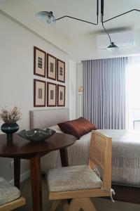 a room with a table and a bed and a dining room at The Florentine Suite in Manila +20 photos