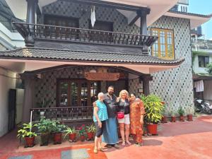 a group of people standing in front of a building at Kuppath Inn in Cochin