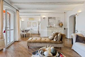 a living room with a couch and a table at Yacht Terrace - Exclusive Waterfront View Porto Cervo Center - by Coral Property in Porto Cervo