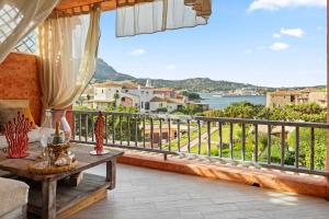 a balcony with a table and a view of the water at Yacht Terrace - Exclusive Waterfront View Porto Cervo Center - by Coral Property in Porto Cervo