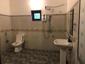 a bathroom with a toilet and a sink at Anjana Villa in Katunayaka +19 photos
