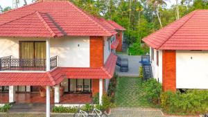 a house with red roofs and a courtyard at River Whisper Villa in Cochin