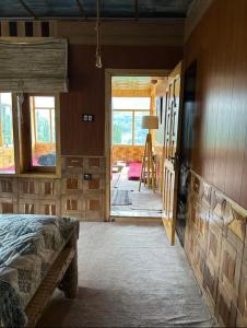 a bedroom with a bed and a view of a doorway at verse hunza in Karimabad Hunza