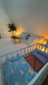 a white bed in a room with a plant at sandhut77 in Al Raka +170 photos