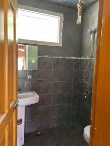 a bathroom with a sink and a toilet and a window at verse hunza in Karimabad Hunza