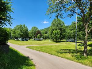 a path in a park with trees and tents at Mobile-Home Living in Gilsdorf