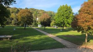 a park with a bench and a path in the grass at Mobile-Home Living in Gilsdorf +1 photo